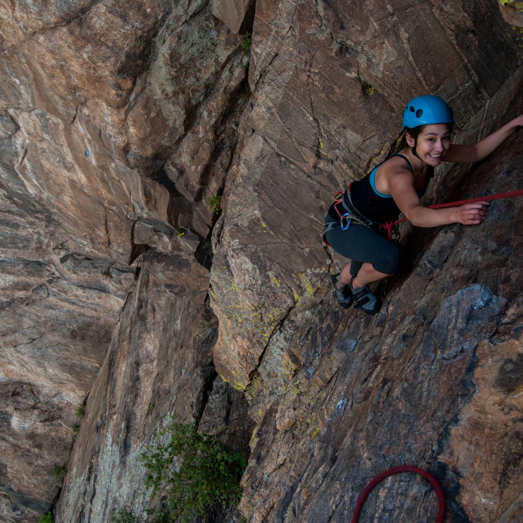 a young man riding on top of a rock