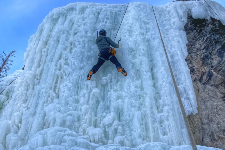 a man riding a snowboard down a snow covered slope