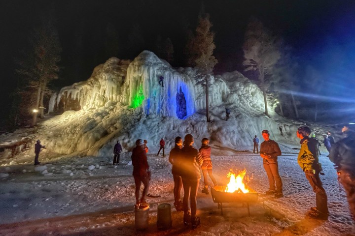 a group of people standing around a fire