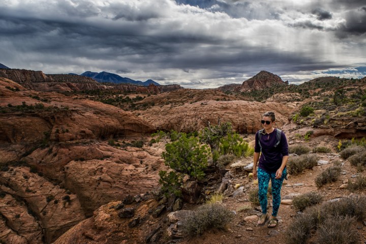 a man standing on a rocky hill