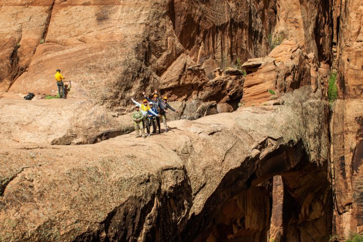 a group of people sitting on a rock