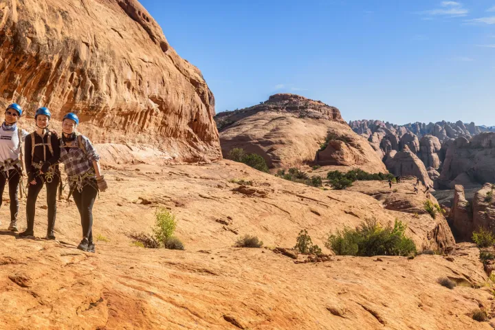 a group of people standing in a canyon