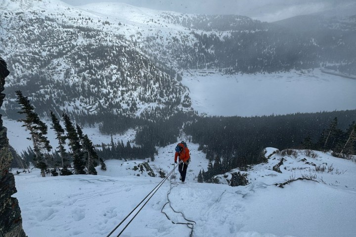 a group of people riding skis on top of a snow covered slope