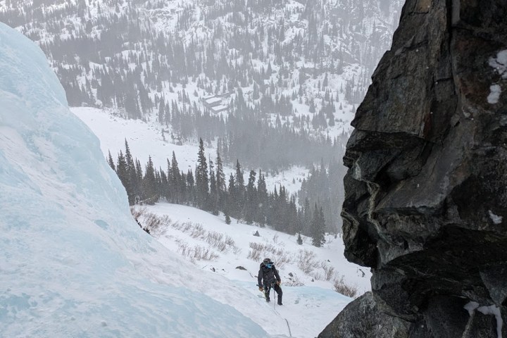 a man standing on top of a snow covered mountain